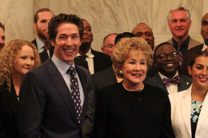 Televangelist Joel Osteen and former Sen. Elizabeth Dole (R-N.C.) pose for a picture with a group of military caregivers at the Russell Senate Office Building in Washington, D.C. on May 21, 2015.