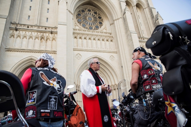 James Magness (C), Bishop for the Armed Forces of the Episcopal Church, speaks with members of Rolling Thunder before the 'Blessing of the Bikes' ceremony at National Cathedral in Washington, May 23, 2014. National Cathedral welcomed members of Rolling Thunder XXVII ahead of their annual ride on the Memorial Day weekend.