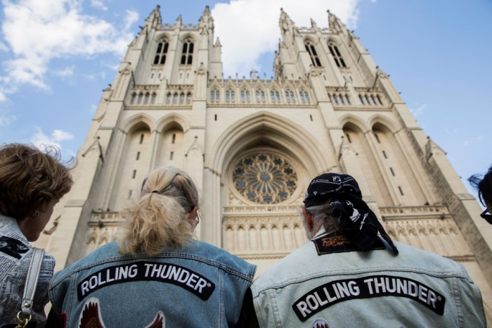 Members of Rolling Thunder listen during the 'Blessing of the Bikes' ceremony at National Cathedral in Washington, May 23, 2014. National Cathedral welcomed members of Rolling Thunder XXVII ahead of their annual ride on the Memorial Day weekend.