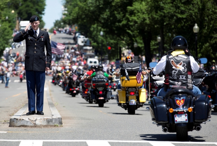 A man in an army uniform salutes as bikers pass him during the Rolling Thunder ride in Washington, May 26, 2013. The 26th Annual Rolling Thunder is organised to show support for veterans past and present, and those who have fallen in war or missing in action.