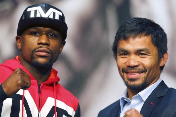 Undefeated WBC/WBA welterweight champion Floyd Mayweather Jr. (L) of the U.S. and WBO welterweight champion Manny Pacquiao of the Philippines pose during a final news conference at the MGM Grand Resort in Las Vegas, Nevada, April 29, 2015.