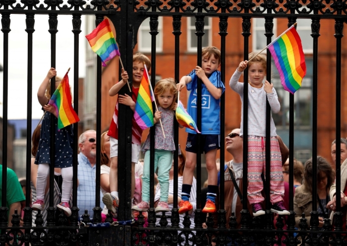 Children wave rainbow flags as they stand with their same-sex marriage supporting parents at Dublin Castle in Dublin, Ireland, May 23, 2015. Irish voters appear to have voted heavily in favor of allowing same-sex marriage in a historic referendum in the traditionally Catholic country, government ministers and opponents of the bill said on Saturday.