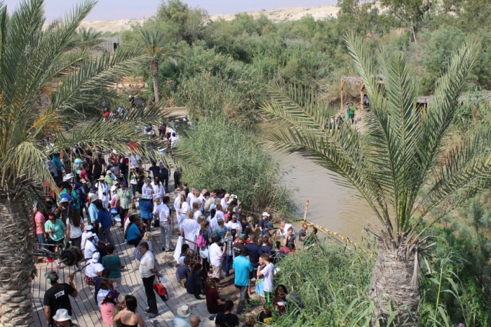 Christians gather at the Jordan River for celebration and baptisms at the border of Israel and Jordan on May 23, 2015.