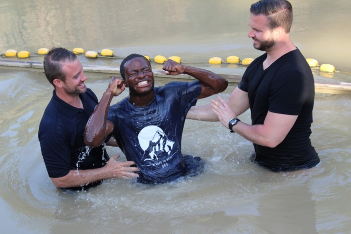 An Oral Roberts University student reacts after being baptized in the Jordan River on May 23, 2015.