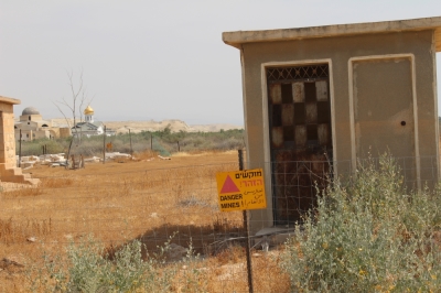 Despite the celebration of the Christians at the Jordan River, a field of landmines nearby speaks of a fragile peace along the border of Israel and Jordan.