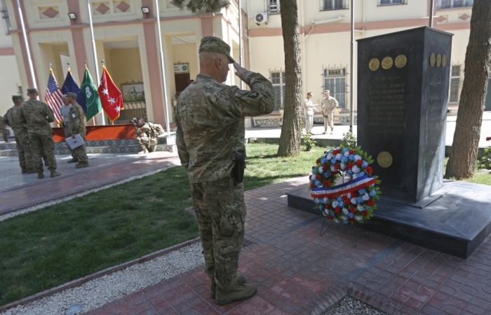 A U.S. officer salutes during a ceremony to commemorate Memorial Day in Kabul, Iraq, May 25, 2015. Memorial Day is observed annually in the U.S. on the last Monday of May to honor the nation's fallen members of the military.