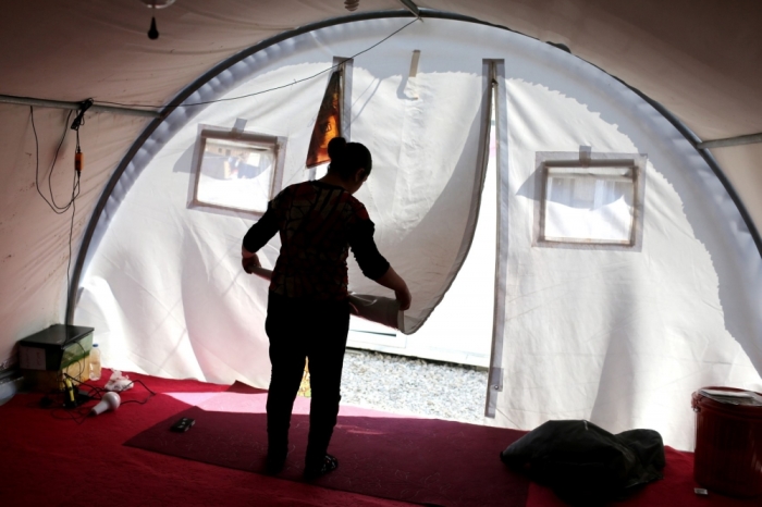 Ilham, a Yazidi woman, folds the curtain of the tent where she lives in a refugee camp near Duhok, February 26, 2015. Reuters photographer Asmaa Waguih: Ilham was kidnapped by Islamic State in August last year and was transported to Tal Afar along with other girls and women. She was raped several times by one of the militants. When Ilham tried to escape, some people she asked for help handed her back to the militants. She managed to get away a few weeks later. At refugee camps in northern Iraq I met and photographed Yazidi women who had survived being kidnapped by Islamic State. I needed government approval to visit some of the camps. The camp officials wanted to protect the women and were wary of the fact that I had a camera. It took a while for the women to get used to me. But when they did, they were happy to share their stories, to tell me what had happened to them. It is very difficult for women living in a quiet, conservative area to admit they have faced sexual violence. In some cases, I heard from camp officials that a woman had been raped, but when I met her she would speak of the brutality of the militants and then mention knowing that some women had even been raped. In general, escapees would try to find a time when the militants were busy working and then seek help. Sometimes people would agree to hide them and then find cars to take them to other areas. At other times they would return the women to Islamic State. Some had managed to escape in groups. Others had family members still being held by the insurgents. It's a disastrous situation for these families' and it's not over yet.