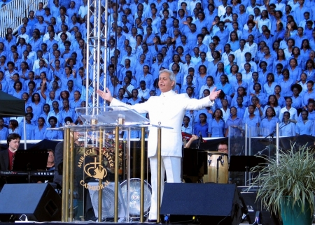 Televangelist Benny Hinn leads prayers at Uganda's national stadium in Kampala, Uganda, May 19, 2007. Wearing a white suit shimmering in the flood lights, the preacher promised a 