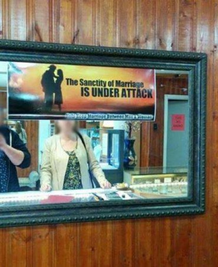 A poster opposing same-sex marriage hangs in Today's Jewellers shop in Mount Pearl, Newfoundland.