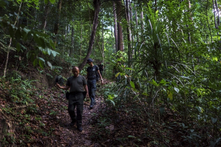Malaysian police officers leave the site of the place where human remains were found, near an abandoned human trafficking camp, in the jungle close to the Thailand border at Bukit Wang Burma in northern Malaysia, May 29, 2015. Thailand has 600 new 'boat people' in temporary holding areas, the country's Deputy Prime Minister General Tanasak Patimapragorn said on Friday.