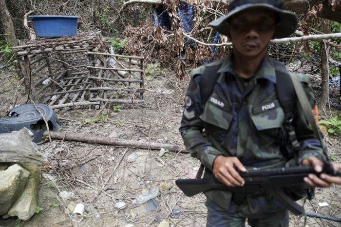 A cage made of barbed wire and bamboo sticks that Malaysian police said was used to hold migrants is seen at the abandoned human trafficking camp in the jungle close the Thailand border at Bukit Wang Burma in northern Malaysia, May 26, 2015. Malaysian police forensic teams, digging with hoes and shovels, began the grim task on Tuesday of exhuming the bodies of dozens of suspected victims of human traffickers found buried around jungle camps near the Thai border.