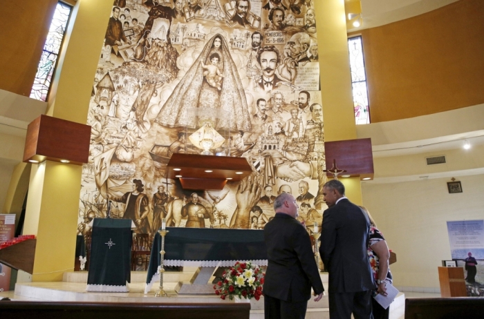 U.S. President Barack Obama visits the Shrine of Our Lady of Charity in Miami, Florida, May 28, 2015. Giving Obama the tour is Father Juan Rumin Dominguez (L).