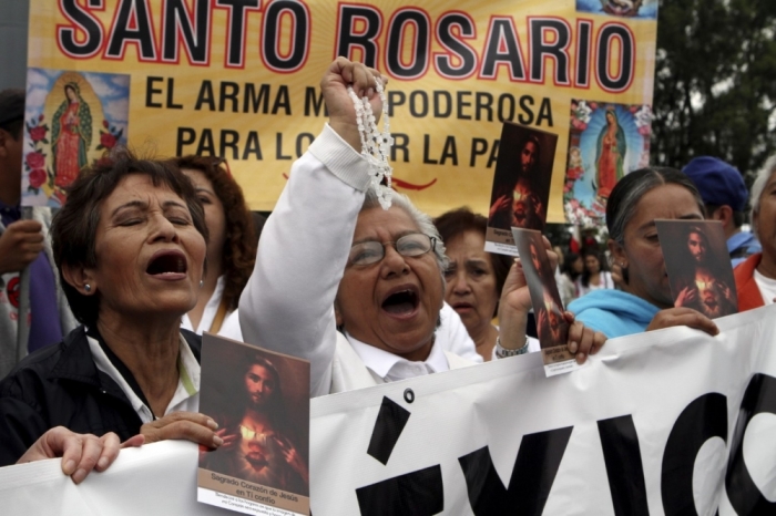 Catholic women yell during a march for peace in Mexico City, May 31, 2015. Participants marched on Sunday to demand increased security and a stop to drug violence throughout Mexico, local media reported.