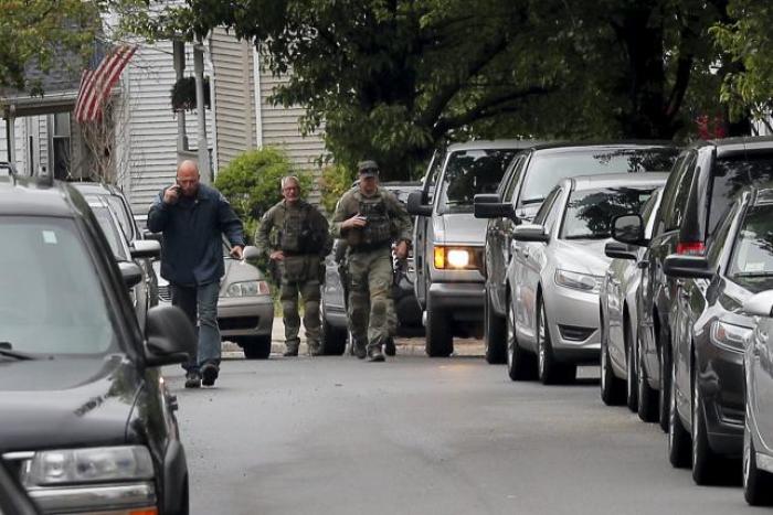 Law enforcement officials are gathered on a residential street in Everett, Massachusetts June 2, 2015 in connection to a man shot dead by law enforcement in Boston after coming at them with a large knife when they tried to question him as part of a terrorism-related incident.