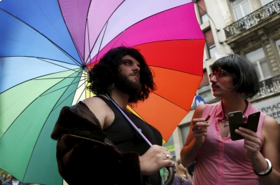Participants stand under a rainbow umbrella as they attend the Belgian lesbian, gay, bisexual and transgender (LGBT) Pride Parade in Brussels, Belgium, May 16, 2015.