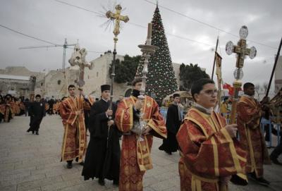 Orthodox Christians are beginning their Christmas celebrations Tuesday. Members of the Greek Orthodox clergy are pictured here outside the Church of the Nativity in the West Bank town of Bethlehem January 6, 2015.