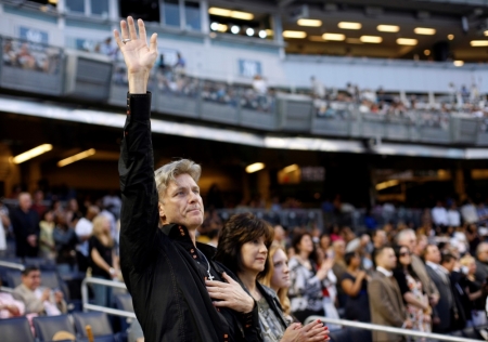 A man raises his hand in prayer during the "Historic Night of Hope" by the evangelist Joel Osteen ministries at Yankee Stadium in New York, April 25, 2009. The service was the first ever non baseball event at the new Yankee Stadium.