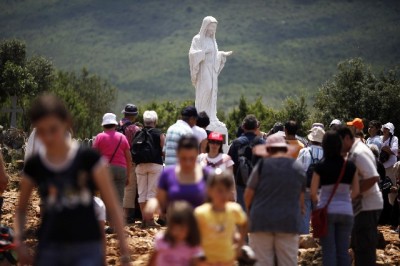 Catholics gather at the site where the Virgin Mary reportedly appeared in an apparition in Medjugorje, 120km (75 miles) south of Sarajevo, June 25, 2009. Millions of pilgrims from all over the world have visited the small Bosnian town after six Bosnian youngsters claimed that the Holy Mary appeared to them there 28 years ago.