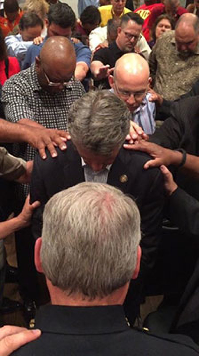 Local pastors in McKinney, Texas, meet with Mayor Brian Loughmiller and Police Chief Greg Conley Monday night, June 8, 2015, to discuss and pray over an altercation between police, local residents and teenagers at a private pool for residents in the Craig Ranch neighborhood of McKinney, located north of Dallas.