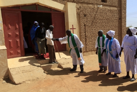 Pastors help South Sudanese worshipers after attending Sunday prayers in Baraka Parish church at Hajj Yusuf, on the outskirts of Khartoum, February 10, 2013. Sudan's President Omar Hassan al-Bashir has said he wants to adopt a