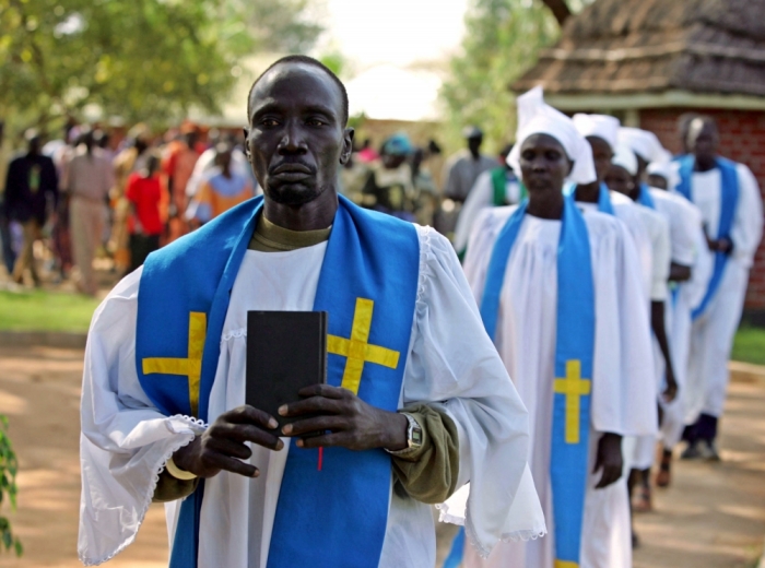 Catholic priests and nuns arrive for a religious ceremony for late John Garang in New Site village in Southern Sudan August 2, 2005. [Southern Sudanese grieved their former leader John Garang around a simple bed on Tuesday and hoped the peace deal he struck would stick under his successor despite rioting over his death that killed 24 people.]