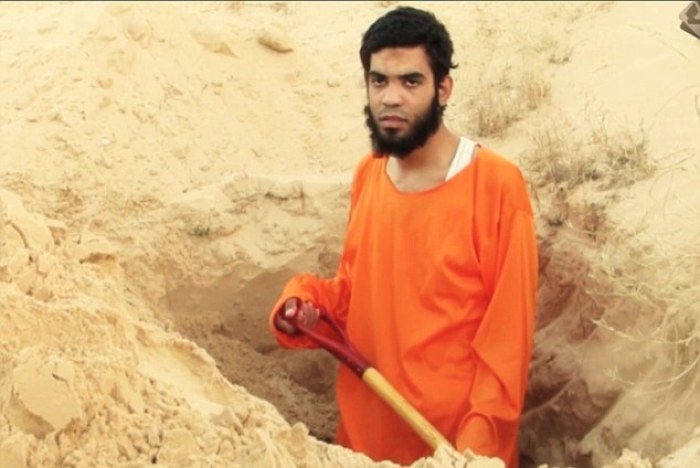 An unnamed Egyptian man purportedly digging his own grave before being executed by ISIS on suspicion of being an agent of Israeli intelligence.