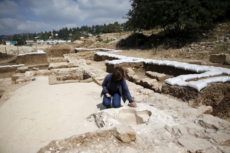 Annette Nagar, director of the excavation for the Israel Antiquities Authority, kneels at a site where an ancient road station, dating back 1,500 years and frequented by travellers between Jerusalem and the coastal plain, was exposed, near Beit Nekofa, west of Jerusalem, Israel, June 10, 2015. A statement from the IAA said the Byzantine-period road station that included a church was discovered during a salvage dig conducted while upgrading the highway between Jerusalem and Tel Aviv.