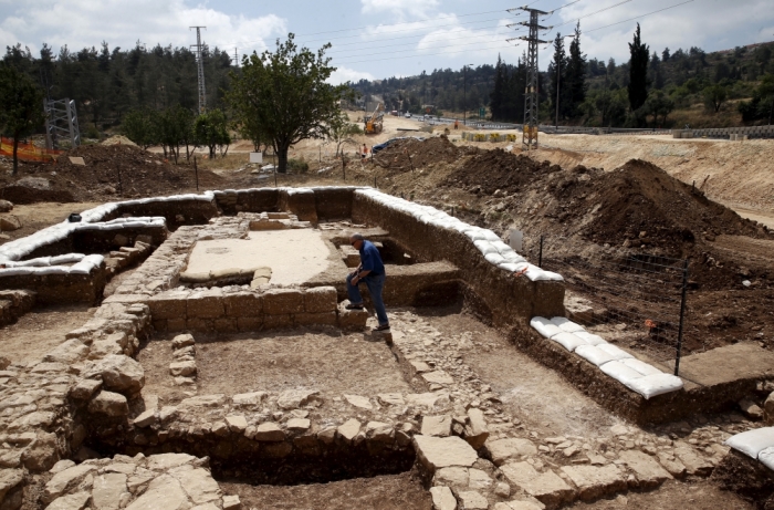 A man walks at an excavation site where an ancient road station, dating back 1,500 years and frequented by travelers between Jerusalem and the coastal plain, was exposed, near Beit Nekofa, west of Jerusalem, Israel, June 10, 2015. A statement from the IAA said the Byzantine-period road station that included a church was discovered during a salvage dig conducted while upgrading the highway between Jerusalem and Tel Aviv.