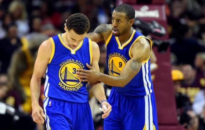 Golden State Warriors guard Andre Iguodala (9) celebrates with guard Stephen Curry (30) during the fourth quarter against the Cleveland Cavaliers in game four of the NBA Finals at Quicken Loans Arena.