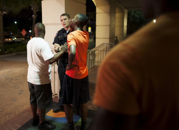 A man reacts while talking to police officer near the scene of shooting at the Emanuel AME Church in Charleston, South Carolina, June 17, 2015. A gunman opened fire on Wednesday evening at the historic African-American church in downtown Charleston, South Carolina.