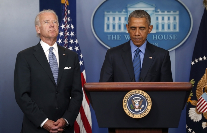 U.S. President Barack Obama (D) delivers remarks in reaction to the shooting deaths of nine people at an African-American church in Charleston, South Carolina, from the podium in the press briefing room of the White House in Washington June 18, 2015. Vice President Joe Biden listens at left.