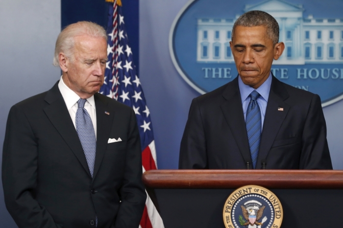 U.S. President Barack Obama (R) delivers remarks in reaction to the shooting deaths of nine people at an African-American church in Charleston, South Carolina, from the podium in the press briefing room of the White House in Washington, June 18, 2015. Vice President Joe Biden listens at left.