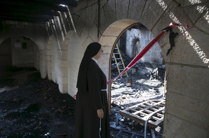 A nun looks at damage caused by a fire in the Church of Loaves and Fishes on the shores of the Sea of Galilee in northern Israel, June 18, 2015. Fire gutted part of the Church on Thursday and investigators suspected arson as a possible cause, a police spokesman said. The church, which Christians believe is where Jesus performed the Miracle of the Multiplication of the Loaves and the Fishes, lies on the shores of the Sea of Galilee and is a traditional site of pilgrimage in the Holy Land.