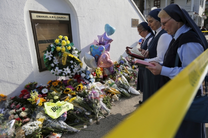 Nuns from the Daughters of St. Paul pray outside the Emanuel African Methodist Episcopal Church in Charleston, South Carolina, June 19, 2015, two days after a mass shooting left nine dead during a Bible study at the church.
