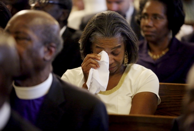 Marie Goff wipes tears from her eyes during a prayer vigil held at Morris Brown AME Church in Charleston, South Carolina June 18, 2015. A white man suspected of killing nine people in a Bible-study group at a historic African-American church in Charleston, South Carolina was arrested on Thursday and U.S. officials are investigating the attack as a hate crime.