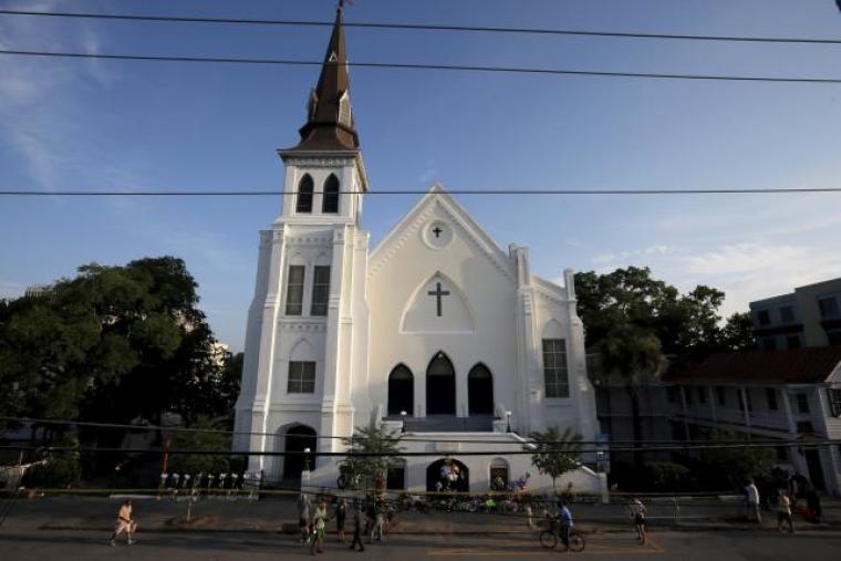 Members of the public continue to pay their respects and leave flowers outside the Emanuel African Methodist Episcopal Church in Charleston, South Carolina June 19, 2015, two days after a mass shooting left nine dead during a bible study at the church.