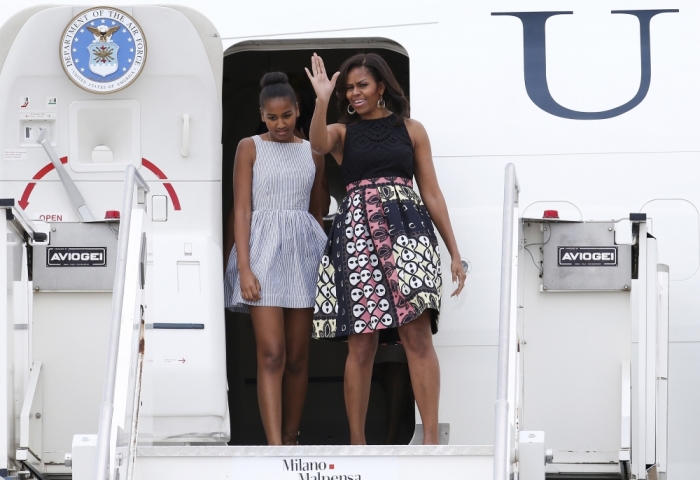 U.S. first lady Michelle Obama (R) arrives with her daughter Sasha at Malpensa airport in Milan, Italy, as part of her European trip June 17, 2015.