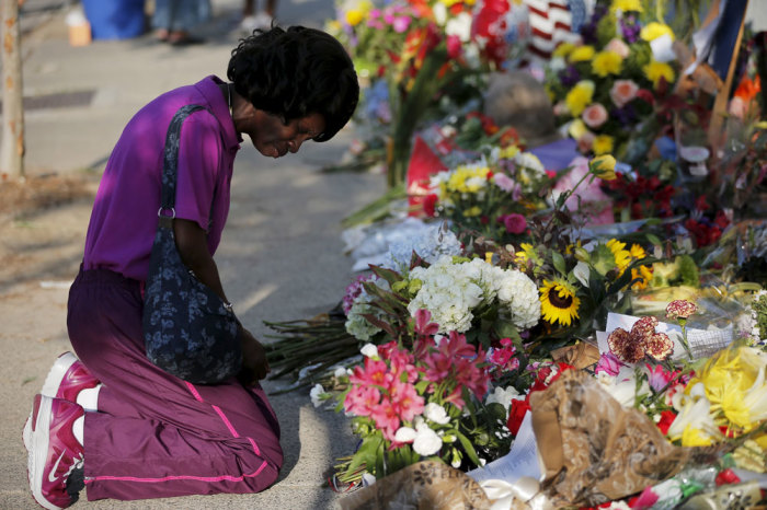 Patricia Bailey prays at a makeshift memorial outside the Emanuel African Methodist Episcopal Church in Charleston, South Carolina June 20, 2015, three days after a mass shooting which left nine people dead during a bible study at the church.