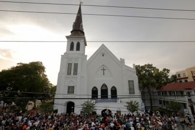 A crowd gathers outside the Emanuel African Methodist Episcopal Church following a prayer vigil nearby in Charleston, South Carolina, June 19, 2015, two days after a mass shooting left nine dead during a Bible study at the church.