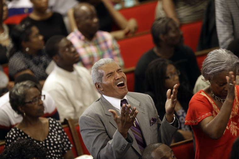 Parishioners sing during services at the Emanuel African Methodist Episcopal Church in Charleston, South Carolina, June 21, 2015. The church held its first service since a mass shooting left nine people dead during a Bible study.