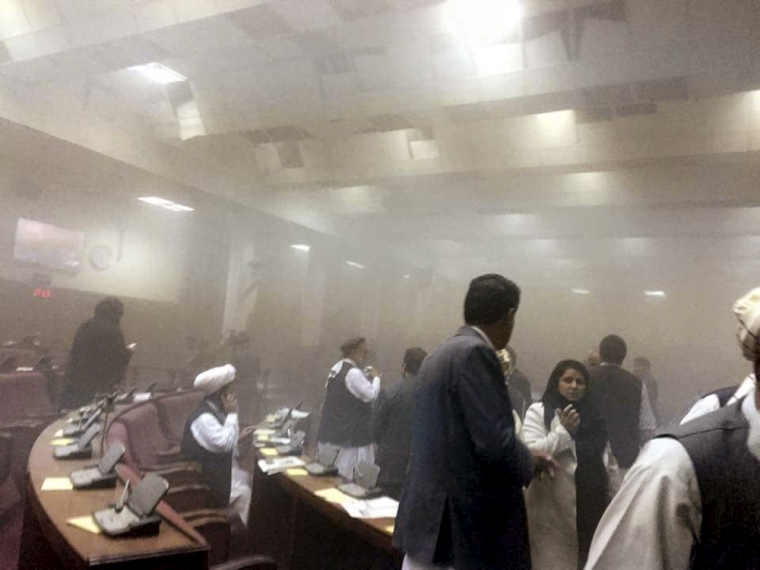 Members of parliament are evacuated after an attack on the Afghan parliament building in Kabul, Afghanistan, June 22, 2015. A Taliban suicide bomber and six gunmen attacked the Afghan parliament on Monday as lawmakers met to consider a new defense minister, and another district in the volatile north fell to the militants as they intensified a summer offensive.