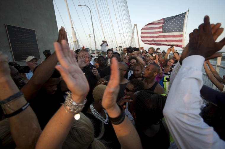 People gather on the Arthur Ravenel Jr. bridge in Charleston, June 21, 2015, after the first service at the Emanuel African Methodist Episcopal Church since a mass shooting left nine people dead. Hundreds of people packed the sweltering Emanuel African Methodist Episcopal Church in Charleston for an emotional memorial service on Sunday just days after a gunman, identified by authorities as Dylann Roof, a 21-year-old white man, shot dead nine black church members.