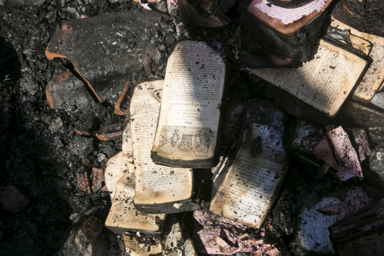 Partially burnt leaflets are seen on the floor of the Church of Loaves and Fishes on the shores of the Sea of Galilee in northern Israel, June 18, 2015. Fire gutted part of the Church on Thursday and investigators suspected arson as a possible cause, a police spokesman said.The church, which Christians believe is where Jesus performed the Miracle of the Multiplication of the Loaves and the Fishes, lies on the shores of the Sea of Galilee and is a traditional site of pilgrimage in the Holy Land.
