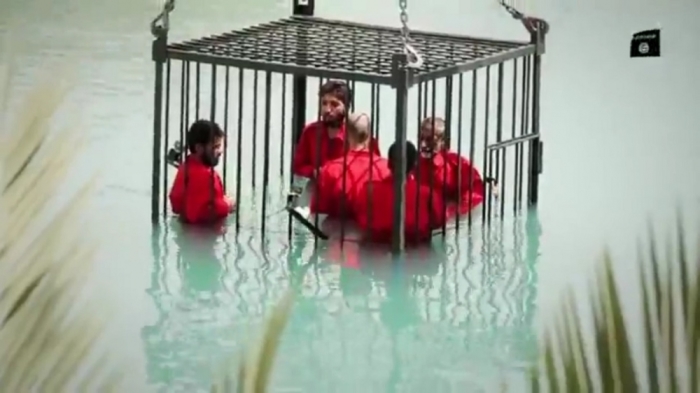 Seven minute long ISIS video from June 2015 shows five men in orange jumpsuits being drowned inside a cage.