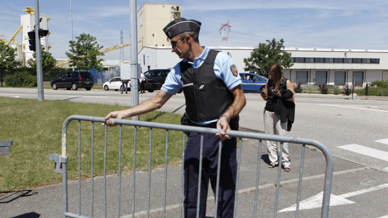 A French Gendarme blocks the access road to the Saint-Quentin-Fallavier industrial area, near Lyon, France, June 26, 2015.