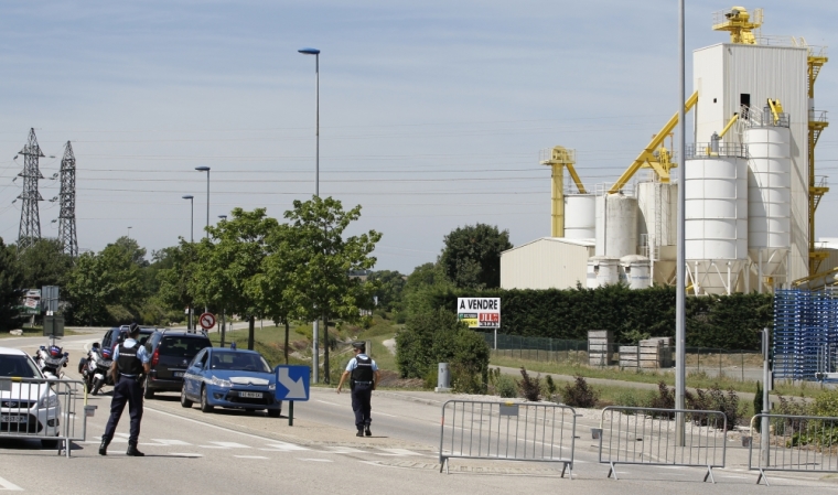 French Gendarmes block the access road to the industrial area of Saint-Quentin-Fallavier, outside Lyon, France, June 26, 2015. A decapitated head covered in Arabic writing was found at a a site belonged to Air Products, a U.S.-based industrial gases technology company, in southeast France on Friday, police sources and French media said, after two assailants rammed a car into the premises, exploding gas containers.