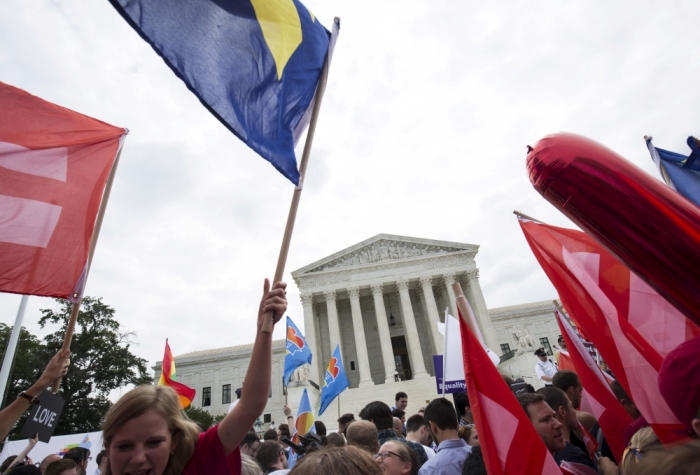 Supporters of gay marriage rally after the U.S. Supreme Court ruled on Friday that the U.S. Constitution provides same-sex couples the right to marry at the Supreme Court in Washington, June 26, 2015.