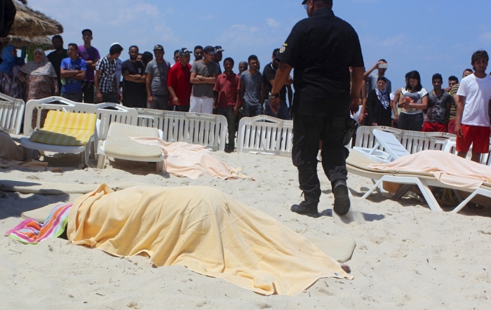 The body of a tourist shot dead by a gunman lies near a beachside hotel in Sousse, Tunisia, June 26, 2015. At least 27 people, including foreign tourists, were killed when at least one gunman opened fire on the Tunisian beachside hotel in the popular resort of Sousse on Friday, an interior ministry spokesman said. Police were still clearing the area around the Imperial Marhaba hotel and the body of one gunman lay at the scene with a Kalashnikov assault rifle after he was shot in an exchange of gunfire, a security source at the scene said.