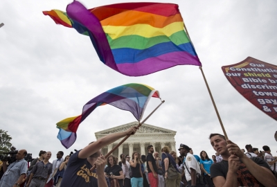 Supporters of gay marriage wave the rainbow flag after the U.S. Supreme Court ruled on Friday that the U.S. Constitution provides same-sex couples the right to marry at the Supreme Court in Washington, June 26, 2015.