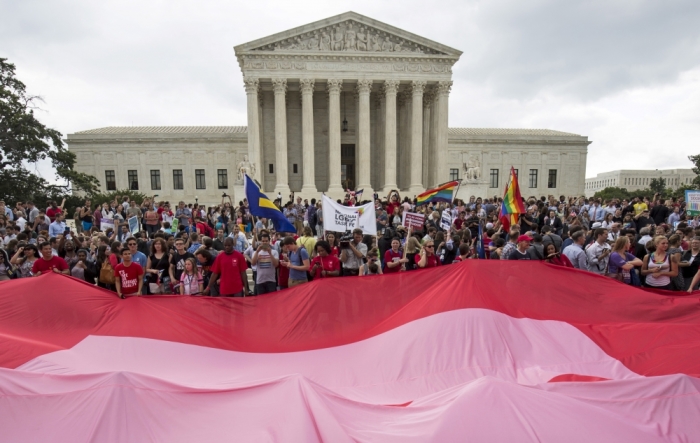 Supporters of gay marriage rally after the U.S. Supreme Court ruled on Friday that the U.S. Constitution provides same-sex couples the right to marry at the Supreme Court in Washington, June 26, 2015. The court ruled 5-4 that the Constitution's guarantees of due process and equal protection under the law mean that states cannot ban same-sex marriages. With the ruling, gay marriage will become legal in all 50 states.